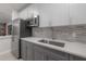 Modern community kitchen with stainless steel appliances and gray cabinets at 1010 Central Ave # 106, St Petersburg, FL 33705