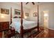 Spacious bedroom with hardwood floors and a four-poster bed at 1112 Jasmine Creek Ct, Sun City Center, FL 33573