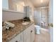 Bathroom features granite vanity and walk-in shower at 112 Saint Pierres Way, Apollo Beach, FL 33572