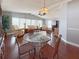 Open concept dining room with glass table and wicker chairs at 112 Saint Pierres Way, Apollo Beach, FL 33572