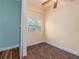 Small bedroom with yellow walls and wood-look tile floors at 11410 Bellamar St, Temple Terrace, FL 33637