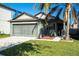 Front view of a single-story house with a green garage at 12720 Hampton Hill Dr, Riverview, FL 33578