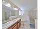 Elegant bathroom with double sinks, bathtub, and shower at 1413 Tahoe Springs Ct, Ruskin, FL 33570