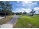 An outdoor bike park features a paved trail, shaded picnic area, and safety fence at 16866 Balance Cv, Land O Lakes, FL 34638