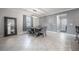 Bright dining area featuring a rustic table and gray chairs at 16866 Balance Cv, Land O Lakes, FL 34638