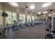 Bright fitness center featuring modern cardio equipment and large windows for natural light at 16866 Balance Cv, Land O Lakes, FL 34638