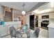 Open concept dining area with glass table and kitchen view at 17960 Gulf Blvd # 103, Redington Shores, FL 33708
