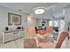 Bright dining room with glass table and coastal decor at 17960 Gulf Blvd # 103, Redington Shores, FL 33708