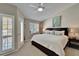 King bedroom with private balcony access and ceiling fan at 17960 Gulf Blvd # 103, Redington Shores, FL 33708