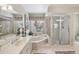 Main bathroom with a walk-in shower and double vanity at 1928 E View Dr, Sun City Center, FL 33573