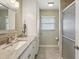 Updated bathroom with granite countertop and walk-in shower at 1928 E View Dr, Sun City Center, FL 33573