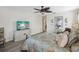 Bedroom with a ceiling fan and a large flat-screen TV at 1928 E View Dr, Sun City Center, FL 33573