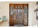 Elegant wooden front door with glass panels and sidelights at 1928 E View Dr, Sun City Center, FL 33573