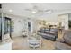 Gathering room with gray leather sofa and access to the kitchen and outdoor area at 1928 E View Dr, Sun City Center, FL 33573