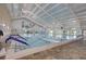 Indoor heated swimming pool with high ceilings at 1928 E View Dr, Sun City Center, FL 33573