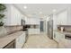 Modern kitchen with white cabinets, granite counters, and stainless steel appliances at 1928 E View Dr, Sun City Center, FL 33573