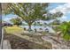 Landscaped backyard with lake access and dock at 1928 E View Dr, Sun City Center, FL 33573