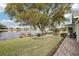 Relaxing lakefront view with a bench and lush landscaping at 1928 E View Dr, Sun City Center, FL 33573