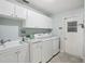 Laundry room with washer, dryer, and extra storage cabinets at 1928 E View Dr, Sun City Center, FL 33573