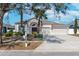 Single-story house with a two-car garage and palm trees at 2044 Heartland Cir, Valrico, FL 33594