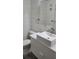 Modern bathroom with white sink, toilet and updated fixtures at 209 Ne Lincoln N Cir # 109, St Petersburg, FL 33702
