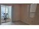 Bedroom with sliding glass doors to a balcony and exercise bike at 209 Ne Lincoln N Cir # 109, St Petersburg, FL 33702