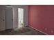 Bedroom with pink walls and grey carpet, bathroom access at 209 Ne Lincoln N Cir # 109, St Petersburg, FL 33702
