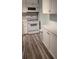 White cabinets, new appliances, and grey flooring at 209 Ne Lincoln N Cir # 109, St Petersburg, FL 33702