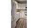 White kitchen with modern appliances and wood-look floors at 209 Ne Lincoln N Cir # 109, St Petersburg, FL 33702