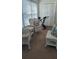 Sunroom with wicker furniture and exercise bike at 209 Ne Lincoln N Cir # 109, St Petersburg, FL 33702