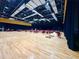 Large ballroom with hardwood floors, stage, and tables with red chairs for events at 2116 Nantucket Dr # 19, Sun City Center, FL 33573