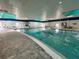 Indoor swimming pool with a tiled deck and seating areas for relaxation and recreation at 2116 Nantucket Dr # 19, Sun City Center, FL 33573