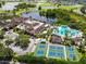 Aerial view of community with clubhouse, pool, and pickleball courts at 2405 New Haven Cir, Sun City Center, FL 33573