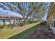 Spacious backyard with mature trees and grassy area at 2405 New Haven Cir, Sun City Center, FL 33573