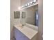 Clean bathroom with a vanity, large mirror and shower at 2405 New Haven Cir, Sun City Center, FL 33573