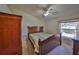 Well-lit bedroom with a large window and wooden furniture at 2405 New Haven Cir, Sun City Center, FL 33573
