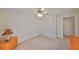 Bedroom with light wood dresser and ceiling fan at 2405 New Haven Cir, Sun City Center, FL 33573