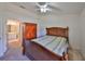 Bright bedroom featuring a wooden bed frame and an ensuite bathroom at 2405 New Haven Cir, Sun City Center, FL 33573