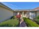 Attractive entryway with lush landscaping and brick walkway at 2405 New Haven Cir, Sun City Center, FL 33573