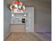 Kitchen features white cabinets and a stained glass light fixture at 2405 New Haven Cir, Sun City Center, FL 33573