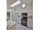 Modern kitchen with white cabinets and black appliances at 2405 New Haven Cir, Sun City Center, FL 33573