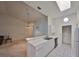 Kitchen with white cabinets, breakfast bar and access to living room at 2405 New Haven Cir, Sun City Center, FL 33573