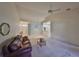 Spacious living room with vaulted ceiling and view into kitchen at 2405 New Haven Cir, Sun City Center, FL 33573