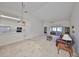 Spacious living room with vaulted ceiling, and sliding doors to lanai at 2405 New Haven Cir, Sun City Center, FL 33573