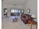 Spacious living room features a leather sofa and sliding glass doors leading to a patio at 2405 New Haven Cir, Sun City Center, FL 33573