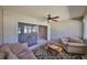 Bright sunroom featuring comfy seating and ceiling fan at 2405 New Haven Cir, Sun City Center, FL 33573