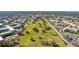 Aerial view of the community with a golf course, surrounding neighborhood, and mature trees at 2468 Florentine Way # 52, Clearwater, FL 33763