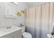 Cozy bathroom featuring coastal decor, a vanity with sink, and a shower with a gradient curtain at 2468 Florentine Way # 52, Clearwater, FL 33763