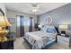 Bedroom with queen bed, blue bedding, and ceiling fan at 2468 Florentine Way # 52, Clearwater, FL 33763