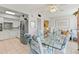 Open dining area with a glass-top table, stylish chairs, and natural light, adjacent to kitchen at 2468 Florentine Way # 52, Clearwater, FL 33763